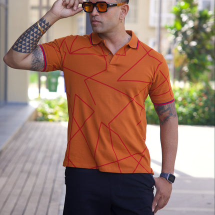 Man wearing an orange patterned polo shirt and black shorts outdoors.