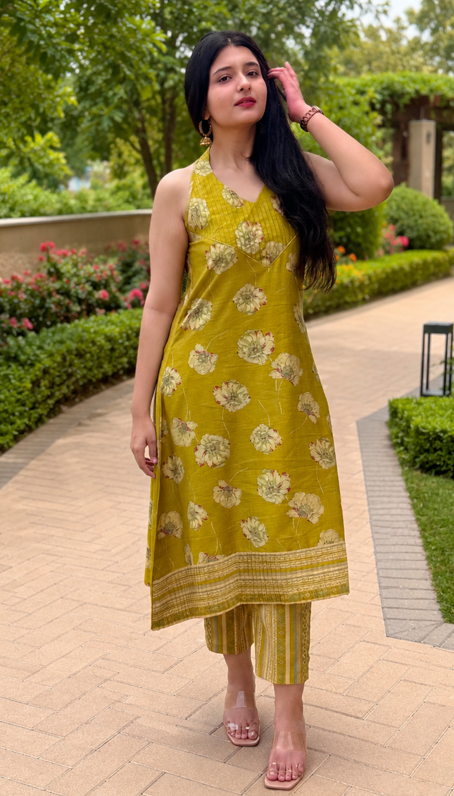 RREFLEKT OLIVE TRACE kurta set featuring floral prints, sleeveless V-neck design, and matching striped pants in olive green.