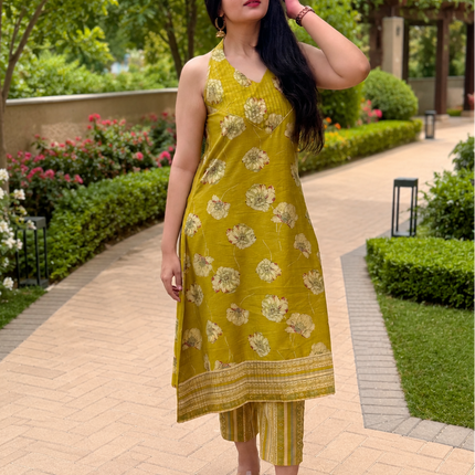 RREFLEKT OLIVE TRACE kurta set featuring floral prints, sleeveless V-neck design, and matching striped pants in olive green.