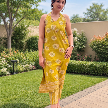 Elegant olive green floral printed kurta set for women with coordinated striped pants and comfortable summer styling.