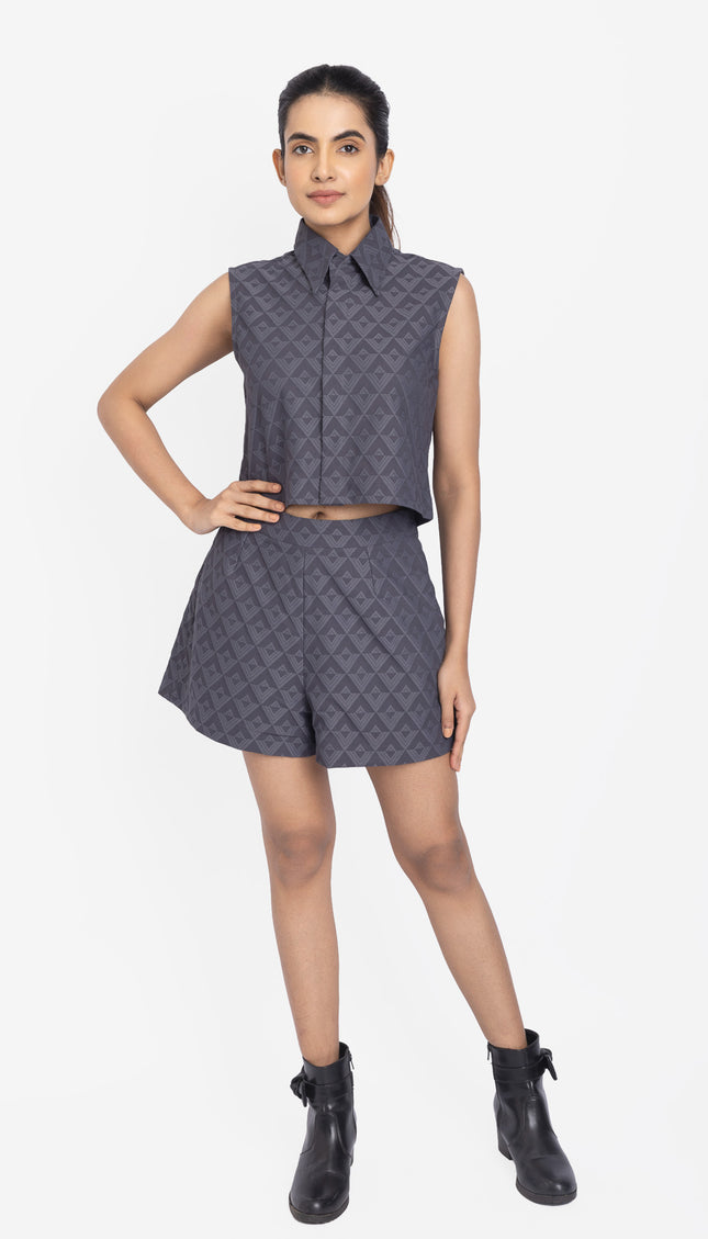 Woman wearing a patterned sleeveless top and shorts