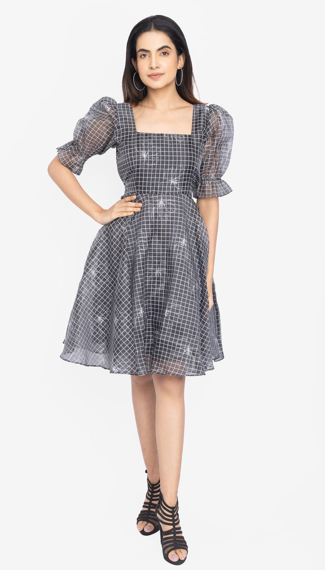 Woman wearing a checkered dress with puff sleeves