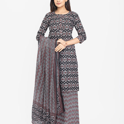 Woman wearing a patterned dress with a matching dupatta