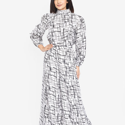 Woman wearing a black and white patterned dress