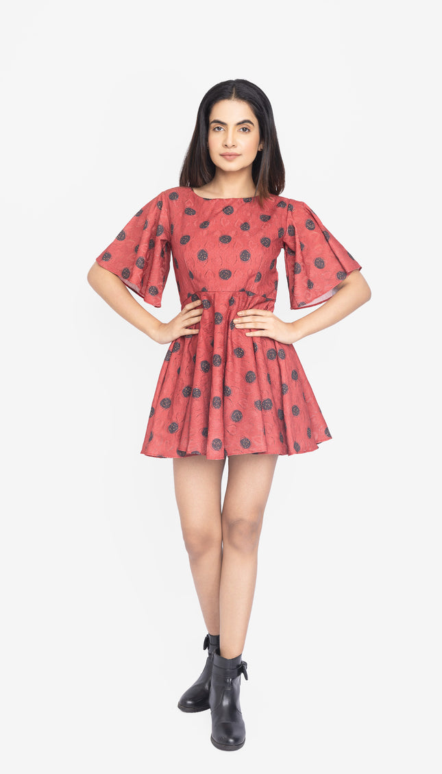 Woman wearing a red dress with black polka dots