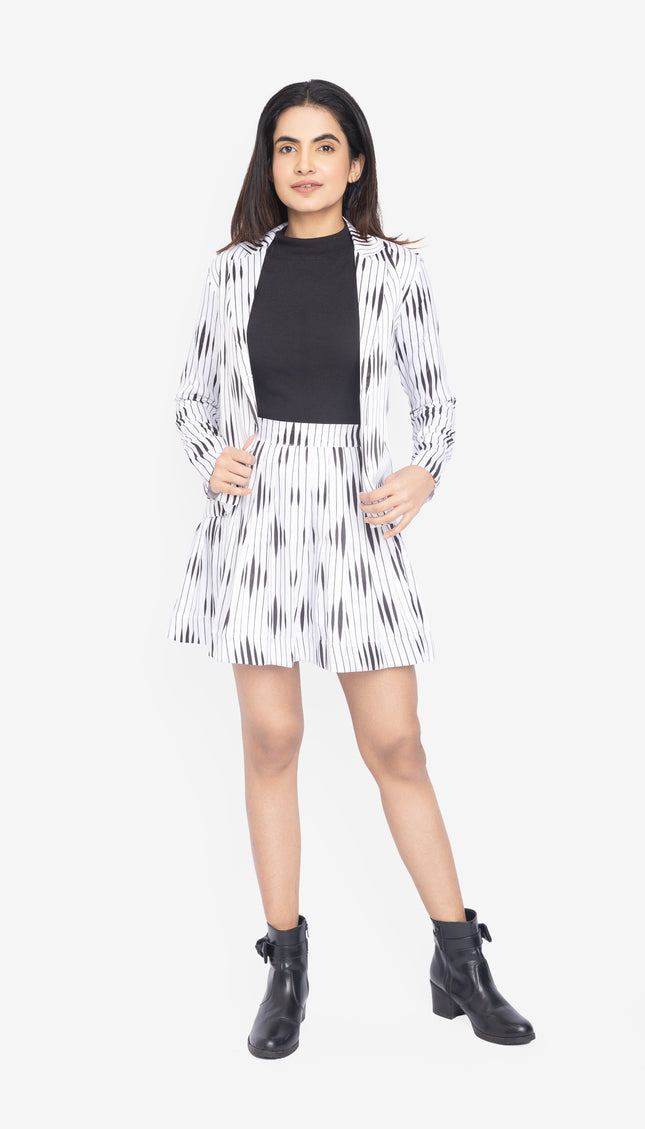 Woman wearing a black and white patterned co-ords with a black top