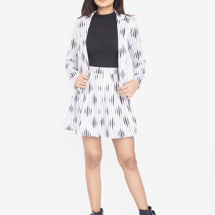 Woman wearing a black and white patterned co-ords with a black top