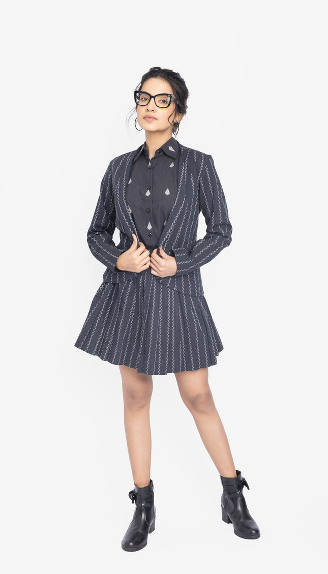 Woman wearing a black and white striped co-ords with a jacket