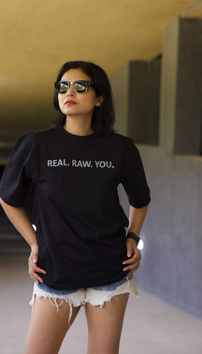 Woman wearing a black t-shirt with text in an underground setting