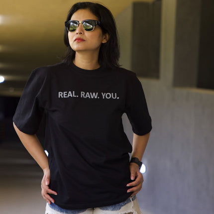 Woman wearing a black t-shirt with text in an underground setting